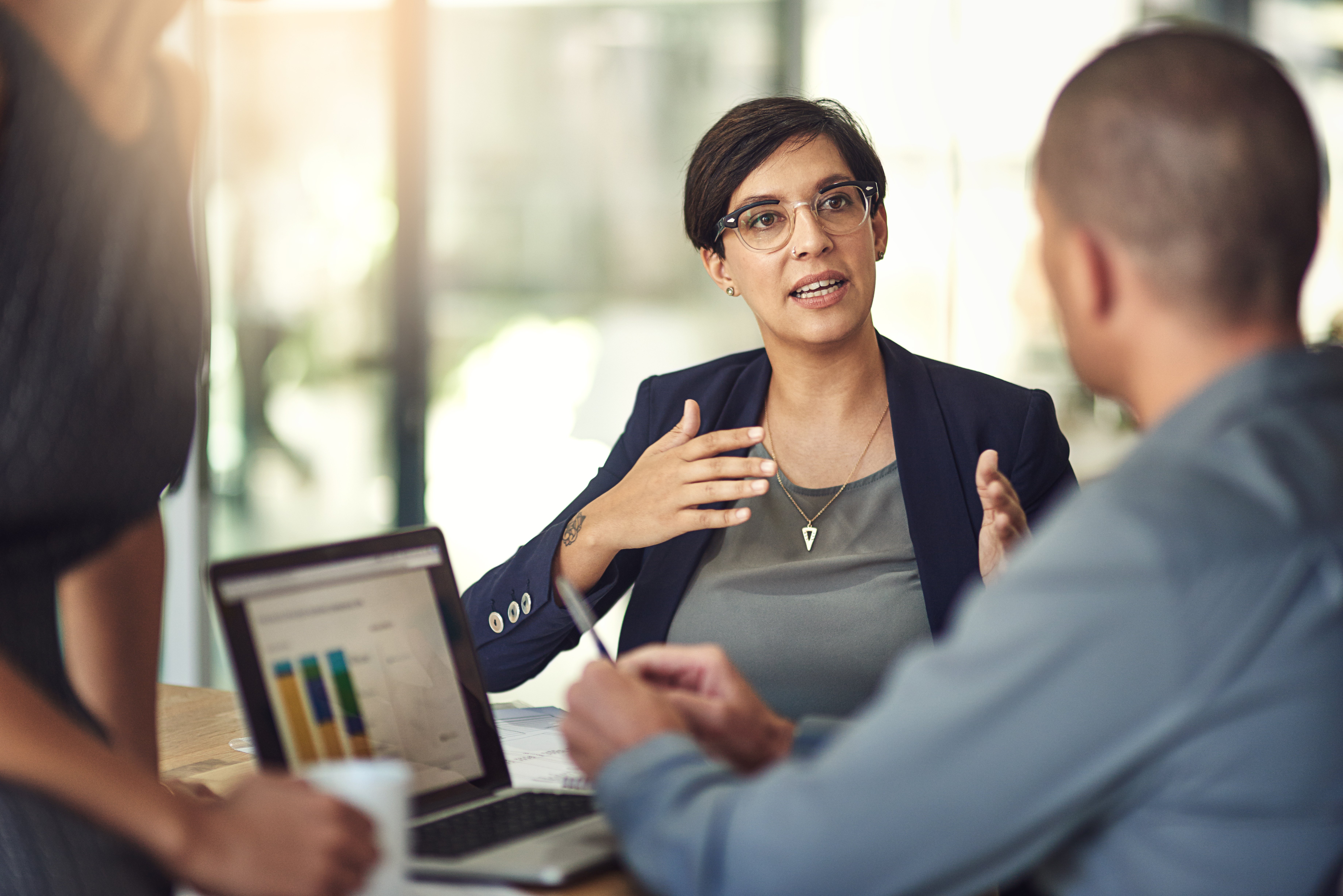 Tax professional reviewing compliance dashboard with colleague